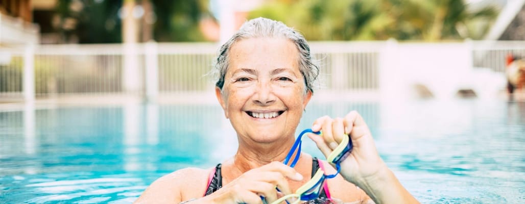 Senior resident enjoying exercise in a swimming pool