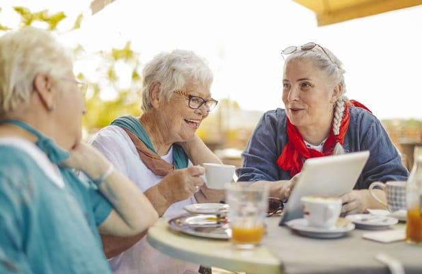 Seniors enjoying coffee and conversation at a table
