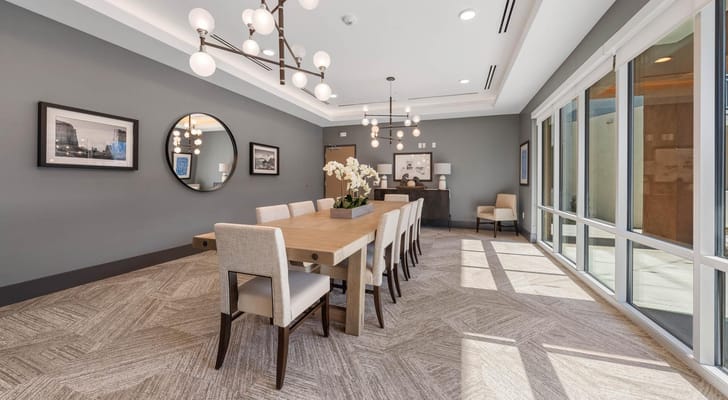 Bright interior common area with a large table and seating