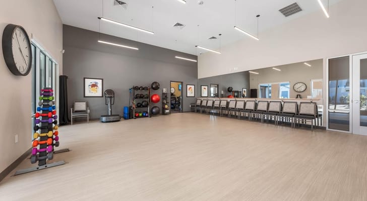 Fitness room with exercise equipment and seating