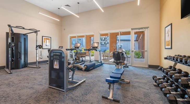 Indoor fitness area with equipment and natural light