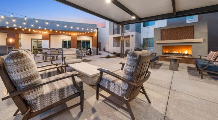 Outdoor seating area with fire pit and string lights