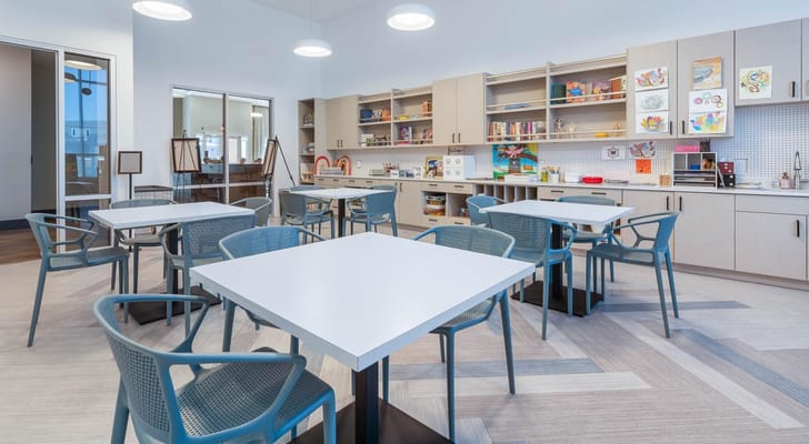 Bright activity room with tables and art supplies