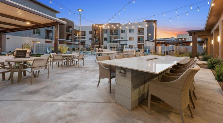 Outdoor gathering space with seating and string lights