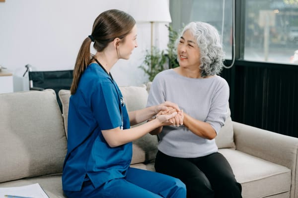 Nurse interacting with a senior resident in a cozy living area