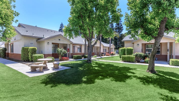 Exterior view of Brookside Senior Apartments with landscaped grounds
