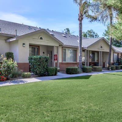 Exterior view of senior apartments with landscaped garden