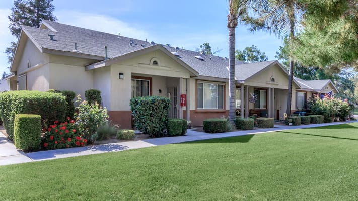 Exterior view of senior apartments with landscaped area