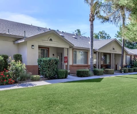 Exterior view of Brookside Senior Apartments with green lawn