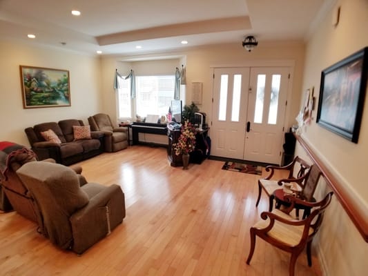 Spacious living room with comfortable seating and a welcoming entryway.