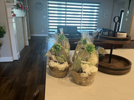 Three decorative gift baskets on a countertop