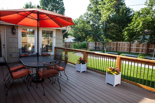 Seating area with table and umbrella on a wooden deck