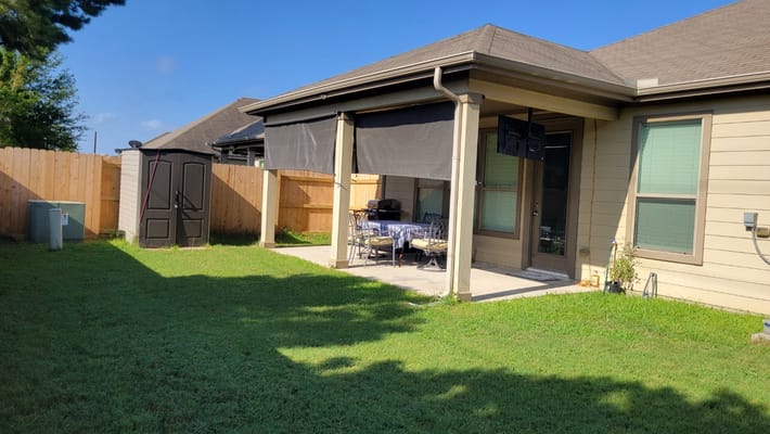 Outdoor patio area with seating and green lawn