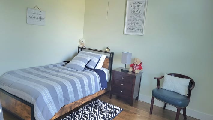 Cozy resident room with a bed and armchair