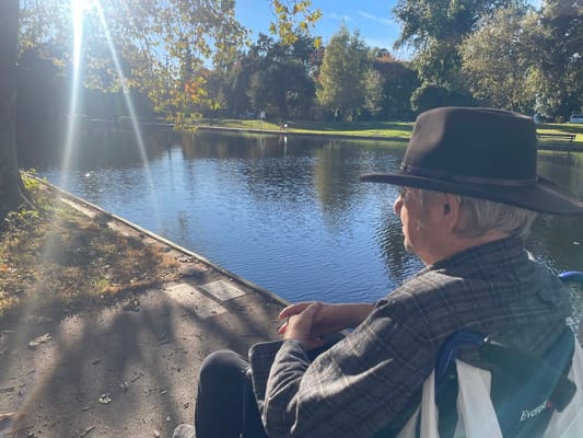 A resident enjoying a peaceful view by the water