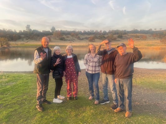 Residents enjoying a sunny day by a lake