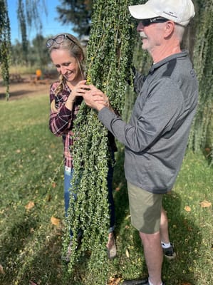 A resident and staff member interacting outdoors.