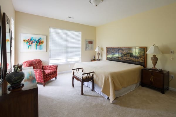Bright and inviting bedroom with a double bed and seating area