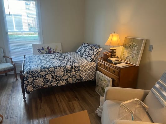 Cozy resident room with floral decor and a bed