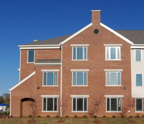 Exterior view of Gateway Place Apartments showing brick facade and large windows.