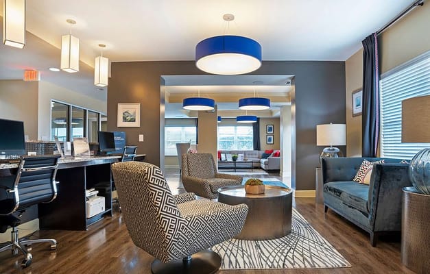 Modern lounge area with comfortable seating and workstations.