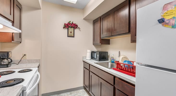 View of a kitchen with appliances and cabinets