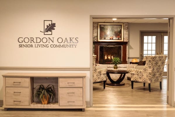 Cozy lobby with seating and a fireplace at Gordon Oaks Senior Living Community