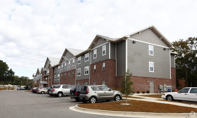 Exterior view of a senior living facility with parking