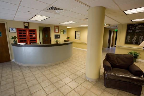 View of the lobby with a reception desk and seating area