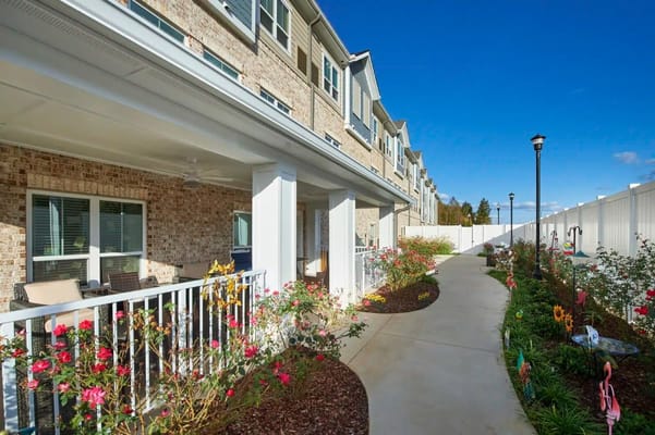 A well-kept outdoor pathway with flowers and seating