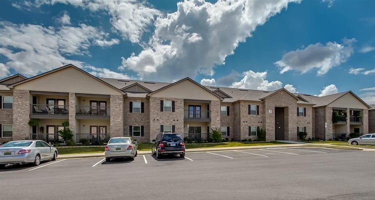 Exterior of Somerville Apartments showing parking and cloudy sky
