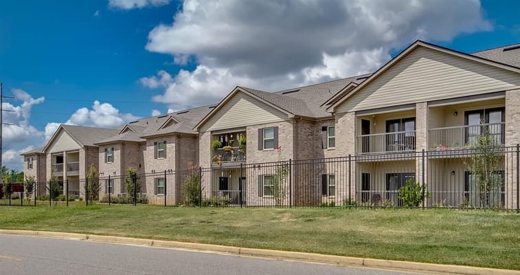 Exterior view of Somerville Apartments with balconies and green space