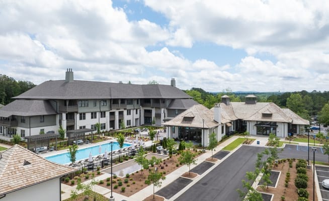 Exterior view of the assisted living facility with pool and gardens