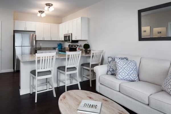 Modern kitchen and living area with a couch and dining bar