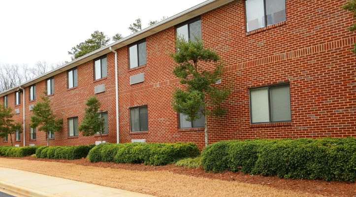Exterior view of a brick building with landscaping