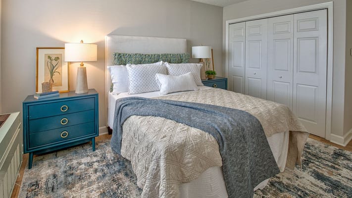 Cozy interior of a resident room with a bed and decor