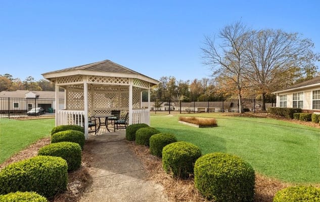 White gazebo in the landscaped garden at Summer Village Camellia Place