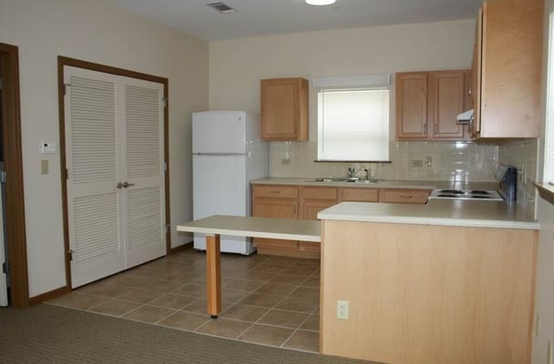 Bright kitchen space with appliances and cabinetry