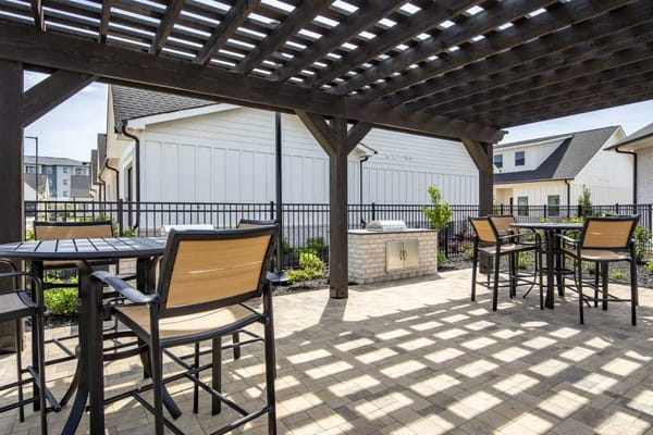 Outdoor patio area with seating and shade.