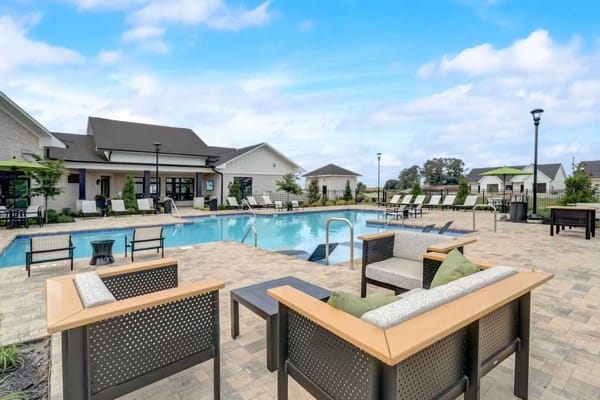 A serene outdoor pool area with seating