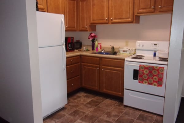 Cozy kitchen area with wooden cabinets and appliances