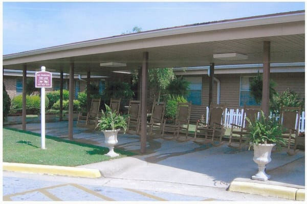 Covered outdoor seating area with rocking chairs