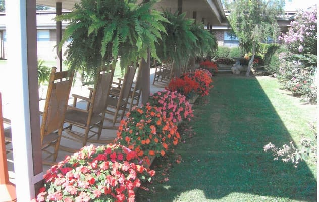 Colorful flowers and rocking chairs on a porch
