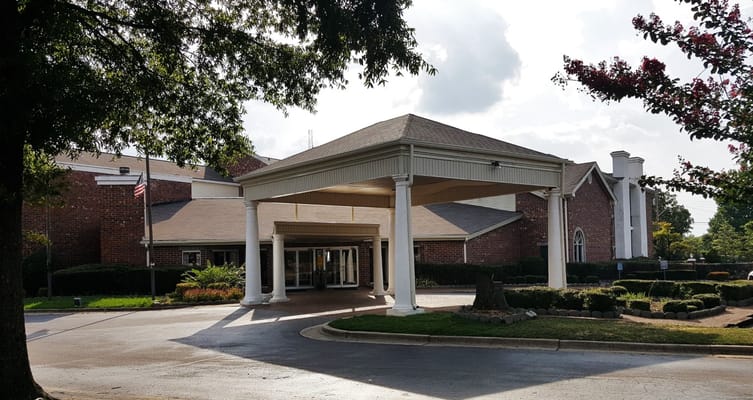 Main entrance of City Center Village Senior Community with covered awning
