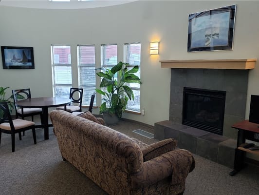 Living room with a sofa, dining table, and fireplace
