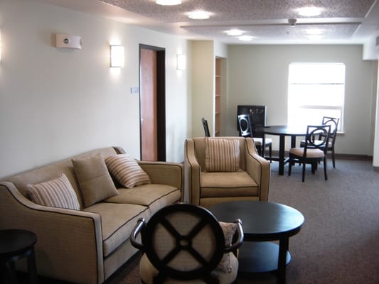 Lounge area with a sofa, chairs, and tables