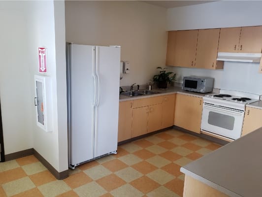 Well-equipped kitchen with refrigerator, stove, and sink.