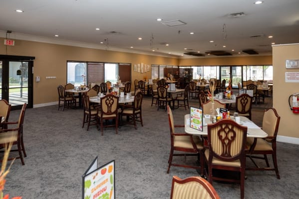 Dining area with tables and chairs set up for residents