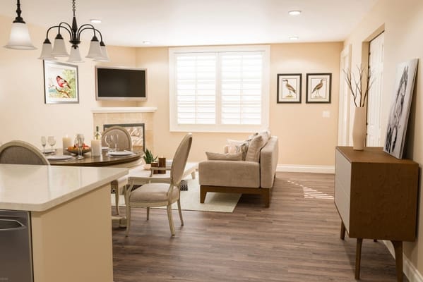 Bright and inviting living room area with a dining table and comfortable seating.