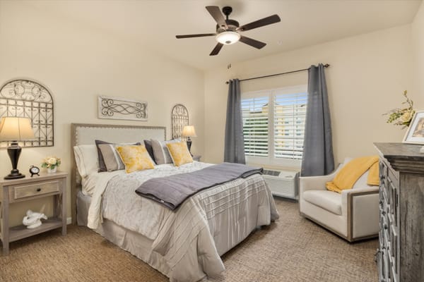 Cozy bedroom with a bed, nightstand, and armchair
